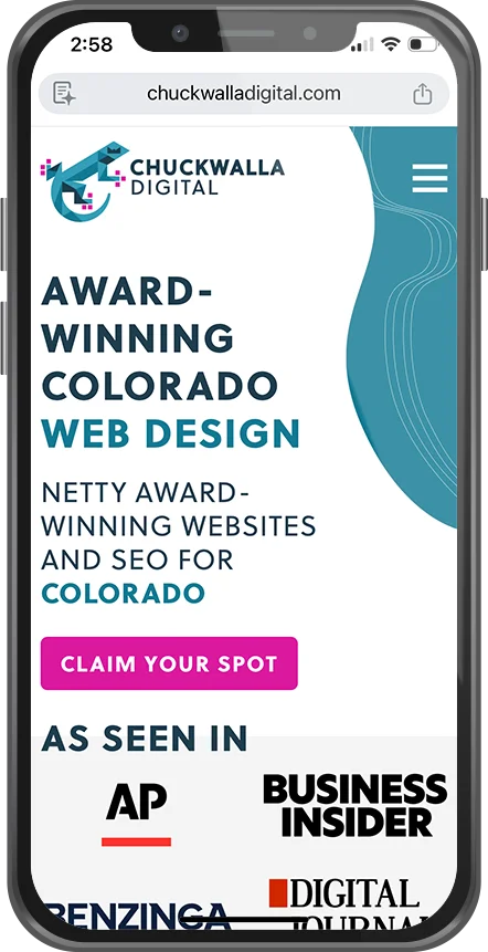 A mobile phone displaying a website for ChuckWalla Digital, promoting Colorado web design services and awards, with a pink call-to-action button labeled 'Claim Your Spot' and logos of media outlets such as AP, Business Insider, and others.